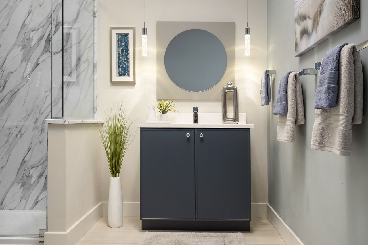 Modern bathroom vanity with soft pendant lighting, calming neutral colors, and minimalist decor creating a spa-like bathroom atmosphere.